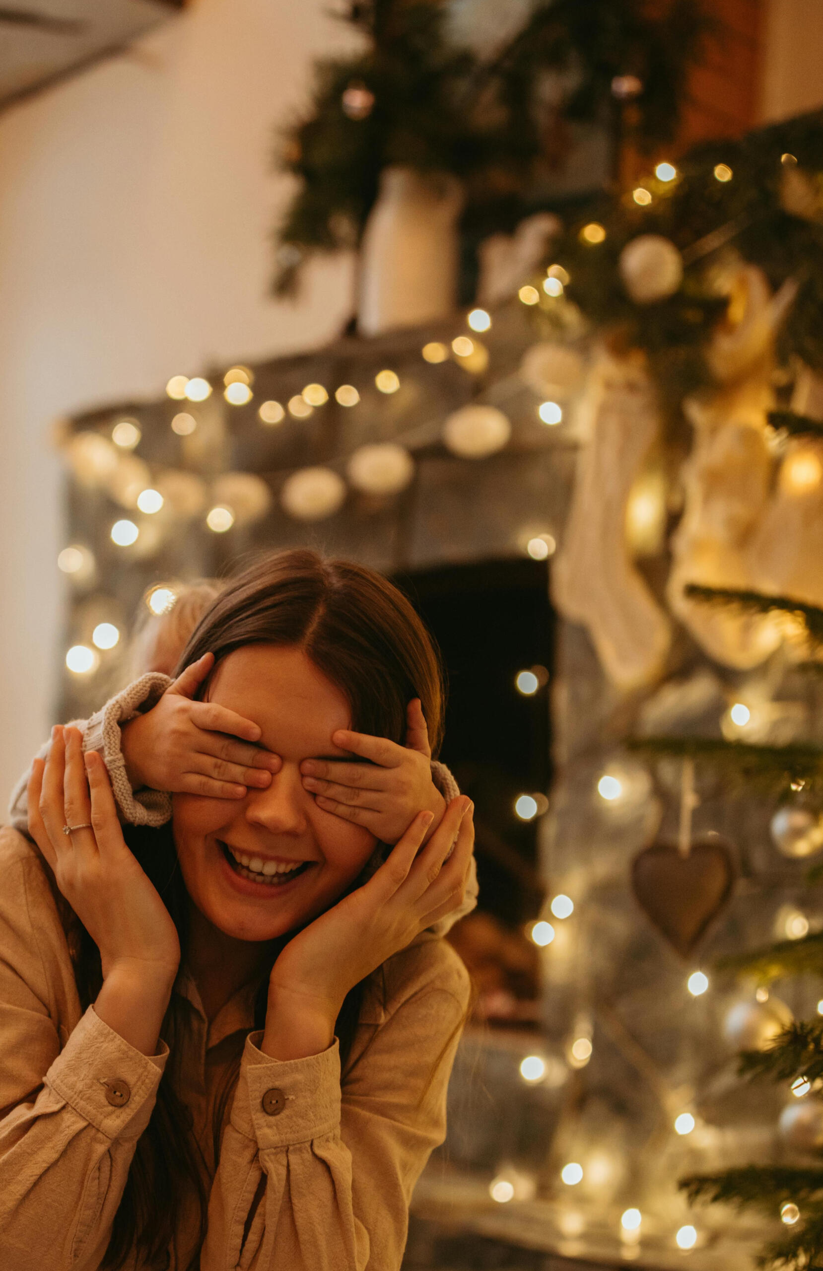 Christmas family session at home Child’s hands covering mum’s eyes while she laughs, Christmas at home